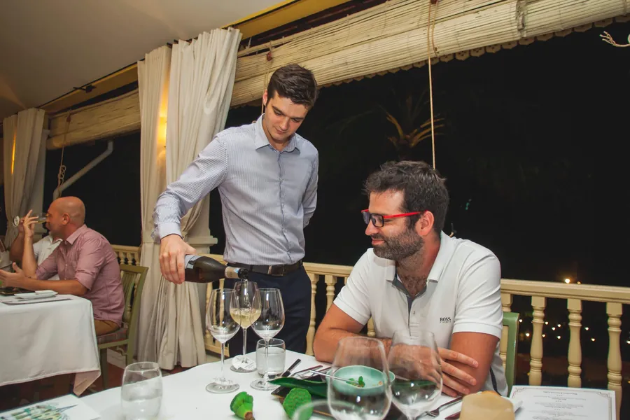 Samuel serving guests at an MGallery hotel